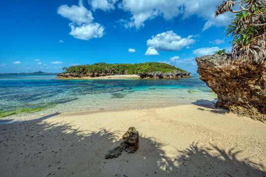 Crystal clear waters of Bise Beach, Motobu District, Okinawa main island. White sand beach with coral outcrops and small islands offshore