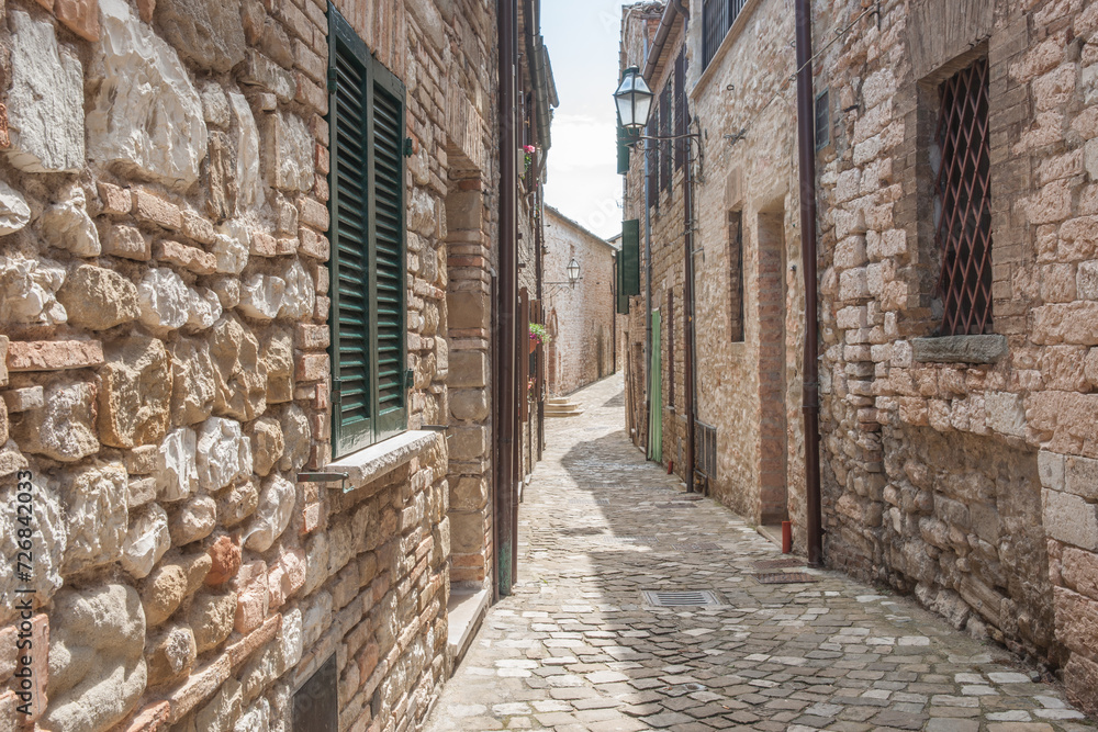 Canvas Prints Typical narrow European village of Frontone street with sun on one side and shadow on other