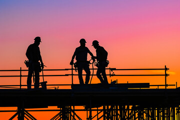 Obraz premium photo construction workers at sunset