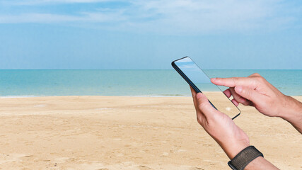 Travelers using phones concept. Basking in summer sun, person captures essence of vacation at beach, using smartphone to seamlessly blend technology with relaxed and enjoyable seaside lifestyle