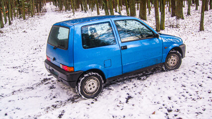 old car standing in the forest or park in the snow, winter, snow

