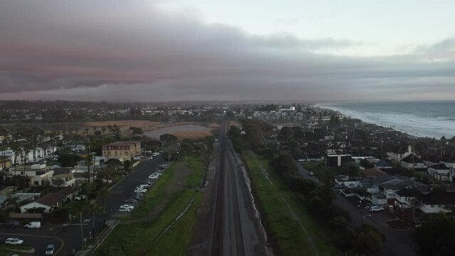 4k Drone Footage, COASTER Commuter Train Rides The Coast, sunset time, after rain, HQ, San Diego, 	Del Mar, Solana Beach, La Jolla, Encinitas, Carlsbad, Oceanside, Railroad crossings, city 