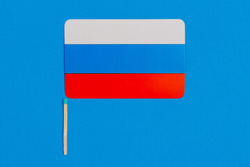 Flagpole in the form of a match with the flag of Russia. Background with selective focus and copy space