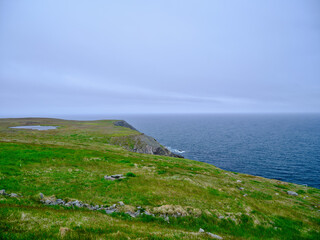 The edge of the land at the Cape Point Lighthouse area on a gray and misty day on the island of Newfoundland - 726861025