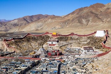 A sweeping vista captures the iconic Kumbum Stupa and Pelkor Chode Monastery, framed by the majestic Gyantse Fort in the heart of Tibet's Gyantse.