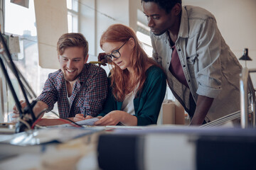 Diverse group of young designers working in an office