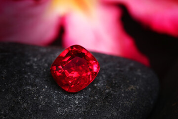Red and black gems scattered on a black surface, surrounded by stones, with elements of romance,...
