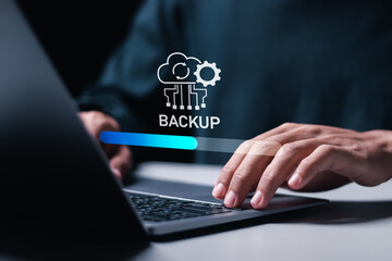 Backup concept, Person use laptop with virtual Backup status bar for data backup management. Online digital data storage and connection service.