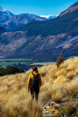 hiker girl walking on a bealey spur track in arthur's pass national park, canterbury, new zealand;...