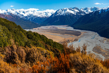 spring panorama of mountains in artur's pass national park, canterbury, new zealand; waimakariri river valley surrounded with massive, snow-capped mountains seen from bealey spur track