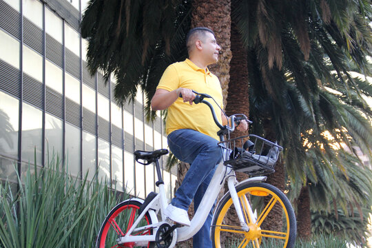 Latino men over 40 years old use public bicycles with free city transportation system tickets to avoid vehicle traffic and not contaminate them