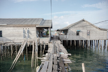poor people's houses that are not in coastal areas, houses made of wood, dangerous, isolated from the city