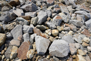 pile of boulders in the coastal area with an irregular sharp texture