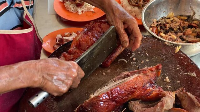 A chef prepares roasted duck at his restaurant in George Town, Penang, Malaysia.