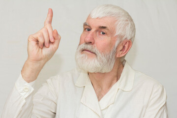 elderly man doctor showing up thumb attention