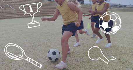 Image of sports icons over happy diverse schoolgirls playing football on sports field - Powered by Adobe