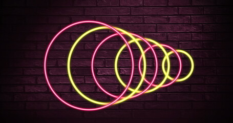 Image of neon circles over dark red brick wall