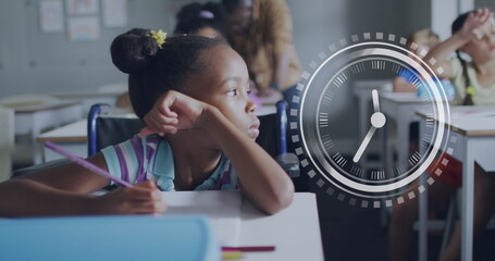 Image of clock over bored african american schoolgirl at desk in class