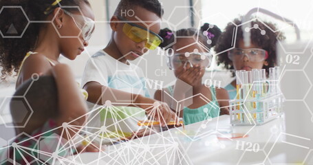 Image of elemental diagrams over happy diverse schoolchildren in chemistry class - Powered by Adobe