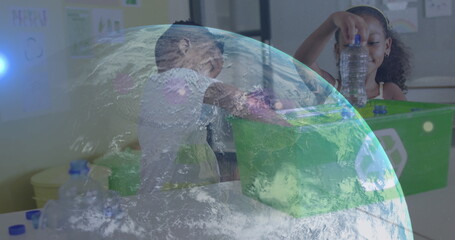 Image of globe over happy african american boy and girl recycling plastic in classroom