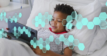 Image of medical data processing over biracial boy patient in bed