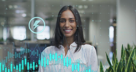 Image of data processing over biracial businesswoman smiling in office