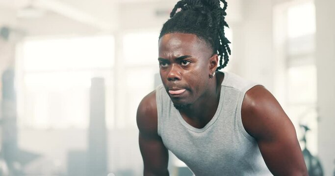 Fitness, sweating and breathing with black man in gym to rest from workout for health or cardio. Exercise, tired and intensity with exhausted young athlete training for performance or improvement