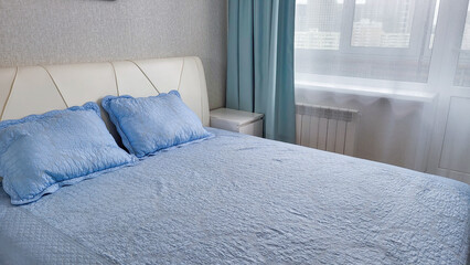 Stylish bedroom interior with comfortable bed, bedside tables