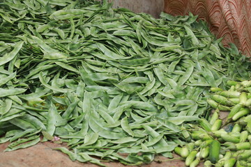 raw green vegetables placed on a large plate