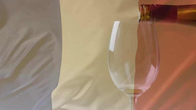 Composite of white wine being poured into glass over flag of france background