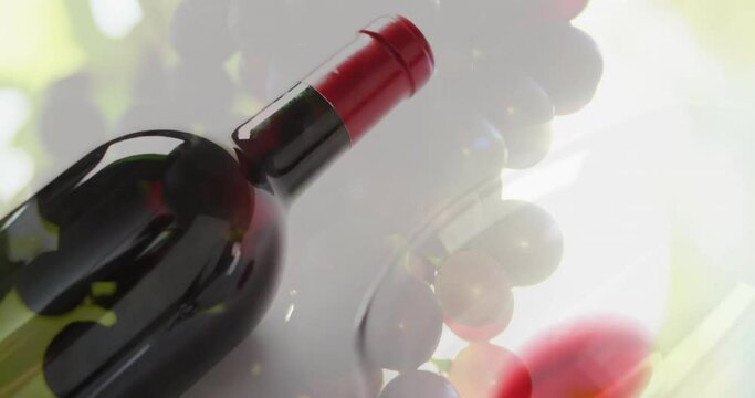 Composite of glass with red wine over grapes background