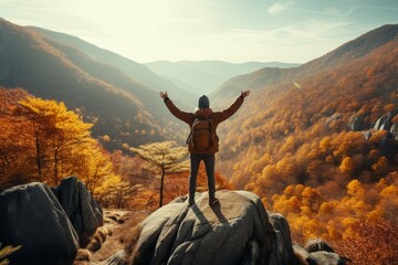 Triumphant hiker on mountain summit - successful young man celebrating climbing achievement - outdoor adventure and active lifestyle concept - obrazy, fototapety, plakaty