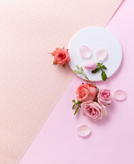 A pastel-toned pink and beige backdrop of pink rose, a view of the top, a decorative podium with a flat line. An empty platform for display cosmetic products, food and props