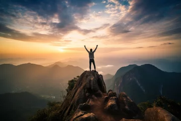 Fotobehang Triumphant hiker on mountain peak - celebrating success - young man conquering forest trails © sorin