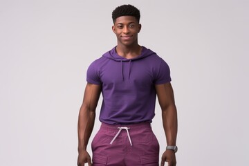 Afro American fitness model torso in purple top with well defined abdominal muscles