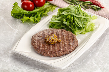 Frilled beef burger cutlet with iceberg