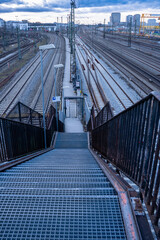 View of a staircase down to the railway tracks from the Donnersberger Bridge in Munich, Germany looking west at dusk