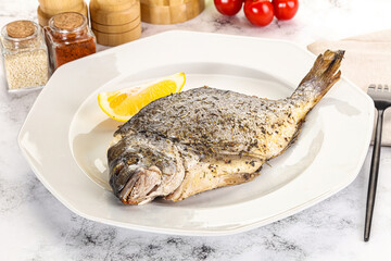 Baked Dorado fish served lemon