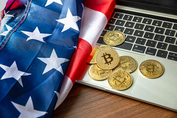 national flag of liberia on the keyboard with bitcoin coins on a grey background.concept