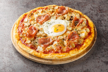 Pizza Bismarck is a style of pizza in Italian cuisine prepared with tomato sauce, mozzarella, mushrooms, prosciutto, and egg closeup on the wooden board on the table. Horizontal