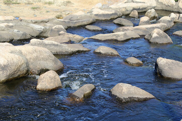 Rock pool with flowing water and stones