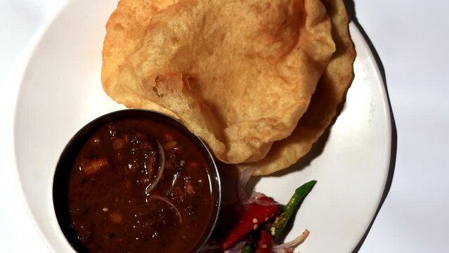 Fresh cooked Chickpea and bread called Chole Bhature in India table top View isolated on white background. Chole Bhature is a food dish popular in the Northern areas of the Indian subcontinent.