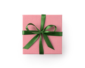 Top view of pink gift box with green ribbon bow isolated on white background