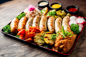fast food set on plate. various meat Bavarian, Frankfurt, German grilled sausages and vegetables
