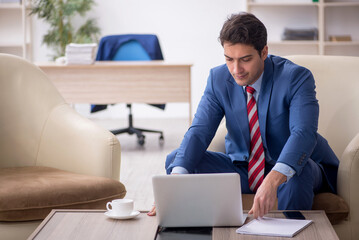 Young male employee sitting in the office