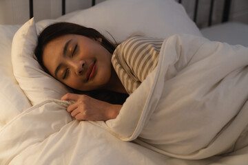 Beautiful Attractive Asian woman sleeping and sweet dream in bed at night