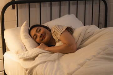 Beautiful Attractive Asian woman sleeping and sweet dream in bed at night