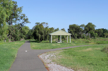 Picnic area, path, grass and trees at Lake Callemondah in Gladstone, Queensland, Australia