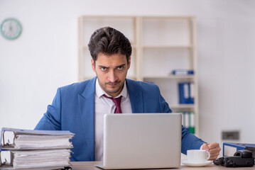 Young male employee working in the office