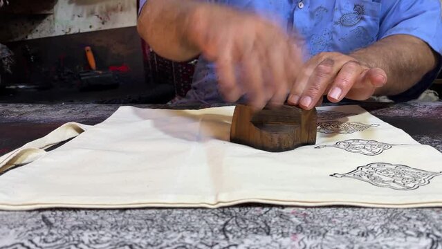 old Persian handicraft man made kalamkari art of natural color dyes hand print on fabric textile workshop traditional design in historical city of ancient Isfahan travel to Esfahan in Iran experience